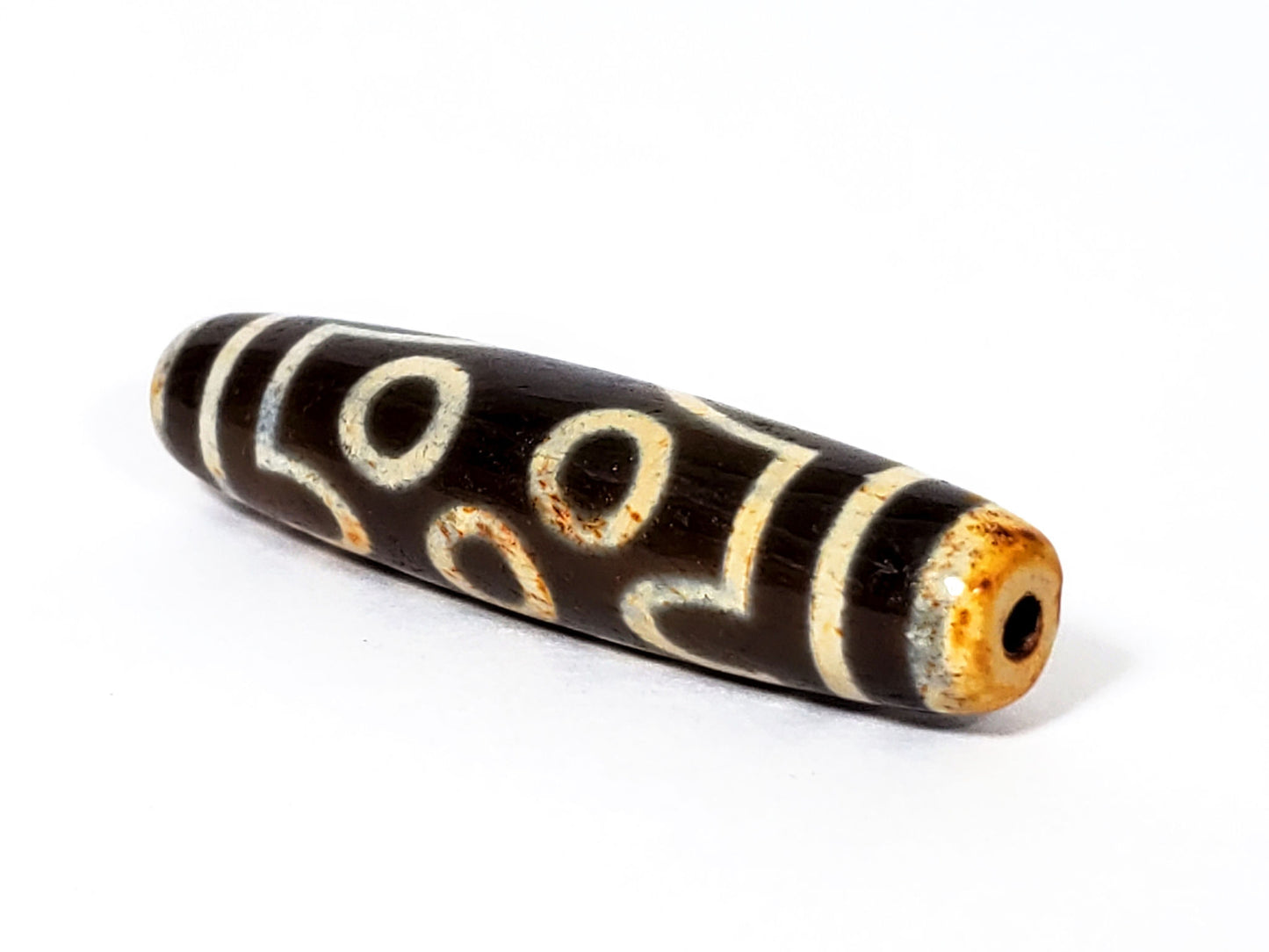 V-FA-062026-7EA5 angled view, honey-amber end cap, clean drill opening