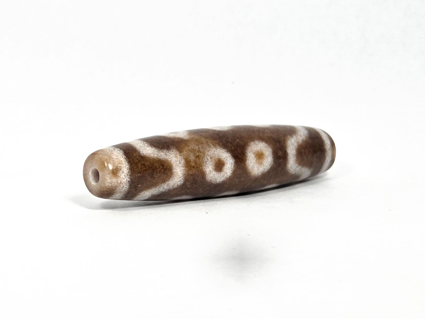 N-083126-10E new ten eye dzi bead drill end view one warm brown matte tip agate unretouched