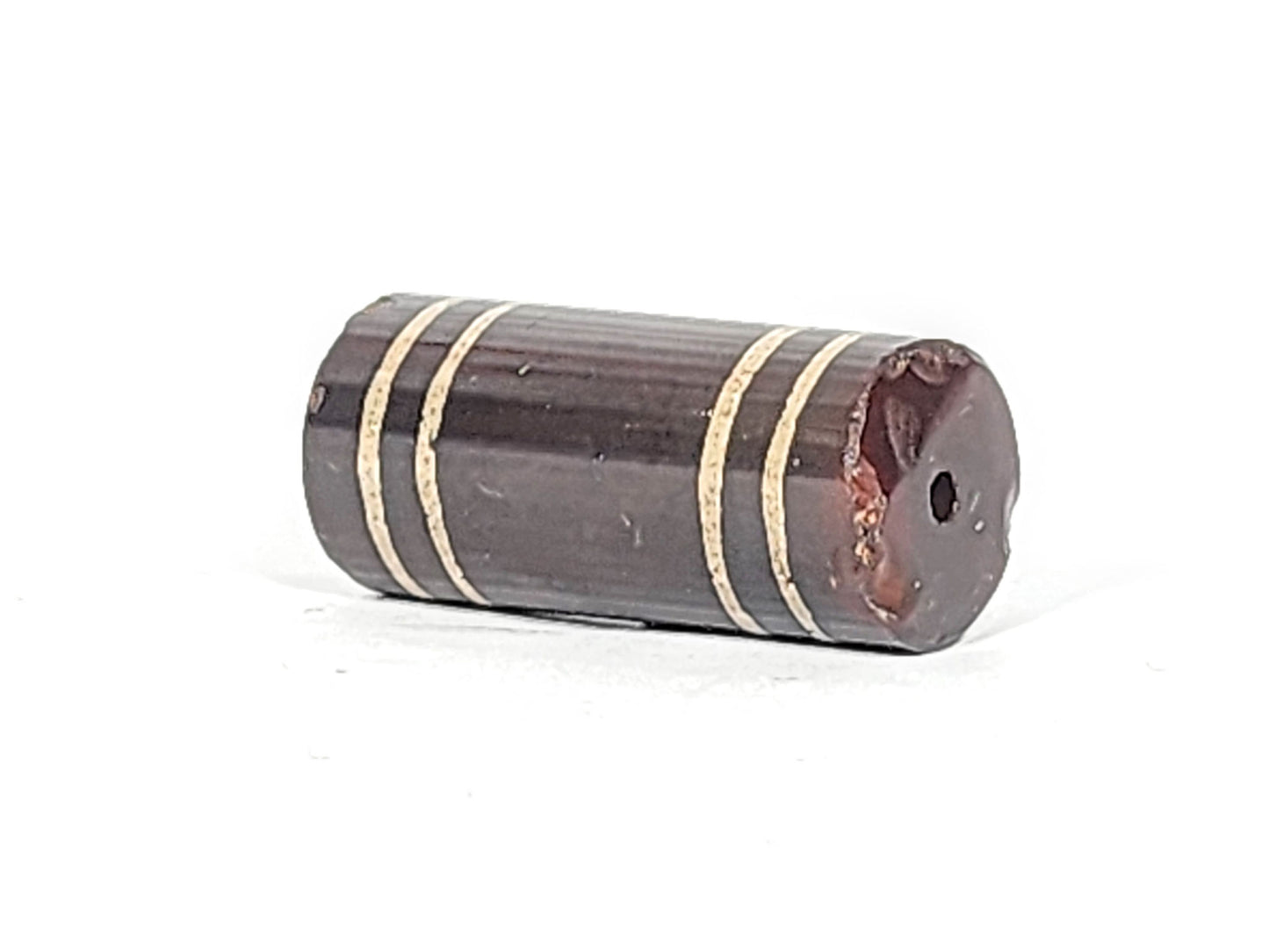 Ac-061426-4Str, right end showing extensive chip and reddish-brown interior exposed, drill hole intact, unretouched