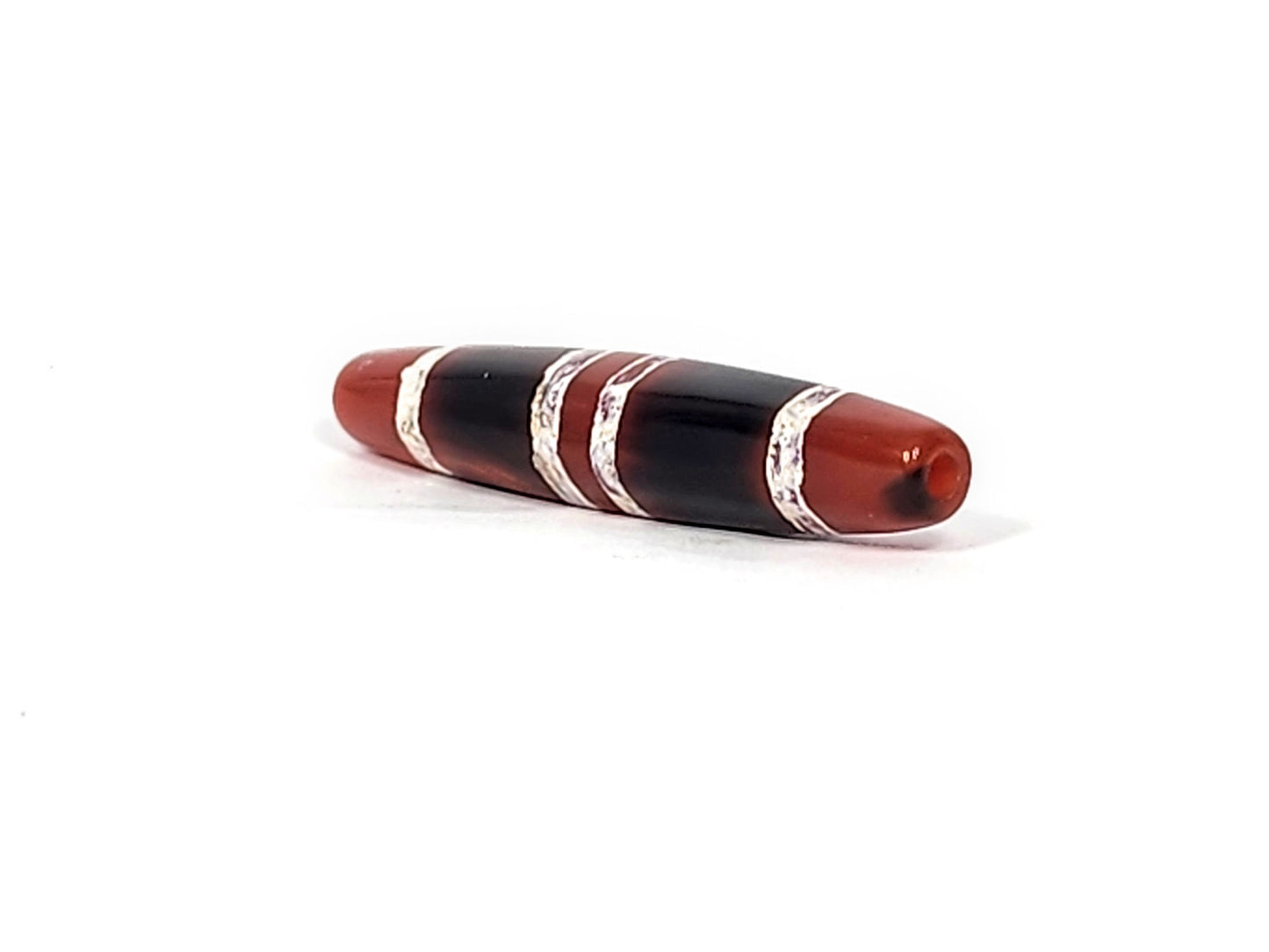 At-122324-3TS antique 3-stripe carnelian dzi, right end cap, cream-white stripe texture, pitch-black body, unretouched