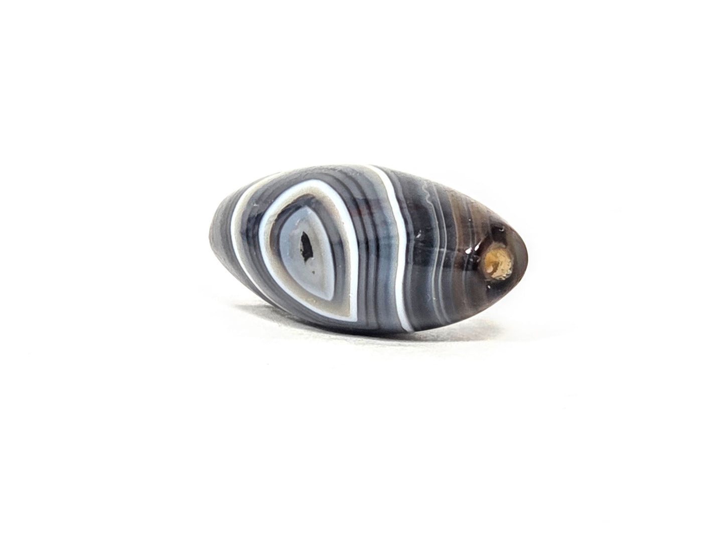 N-N-071026-1E-OLV2 three-quarter end view, eye and drill-hole end visible, orange-brown natural inclusion at end, unretouched