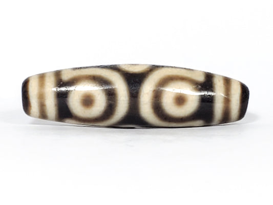 Authentic ancient Tibetan dzi bead with six-eye pattern on Himalayan agate — symbol of luck and fortune