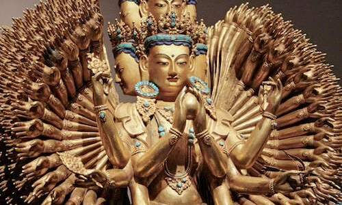 Thousand-armed Avalokiteshvara Chenrezig gilded statue — Tibetan Buddhist bodhisattva of compassion with eleven heads, countless arms radiating outward, hands in prayer mudra, turquoise jewel ornaments