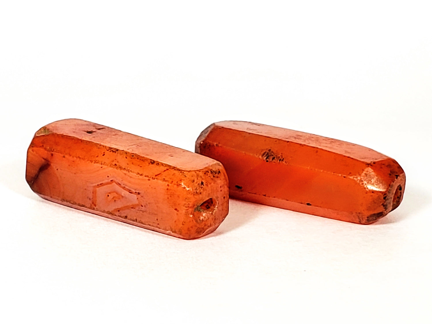 pair of ancient carnelian dzi beads with natural cinnabar inclusions - rare long rectangular shape with bevelled edges.