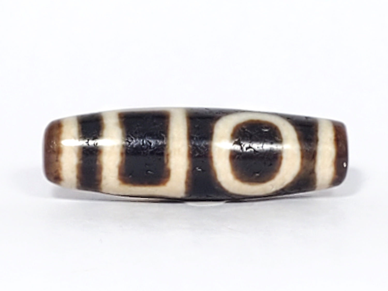 ancient Tibetan dzi bead featuring double heaven & earth pattern