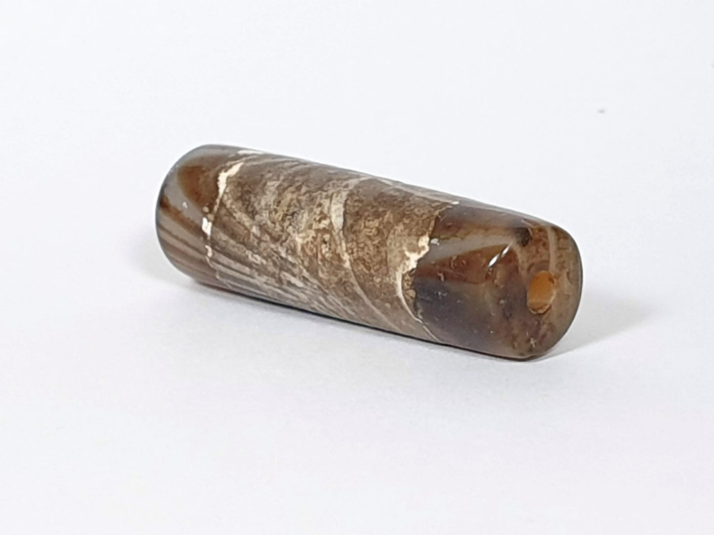 At-030420-1SNP, right end cap, off-centre drill hole with warm reddish-orange interior, calcification field, unretouched
