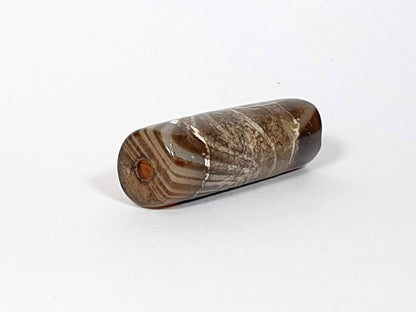 At-030420-1SNP, left end cap, off-centre drill hole, natural agate banding on end face, tobacco-brown body, unretouched