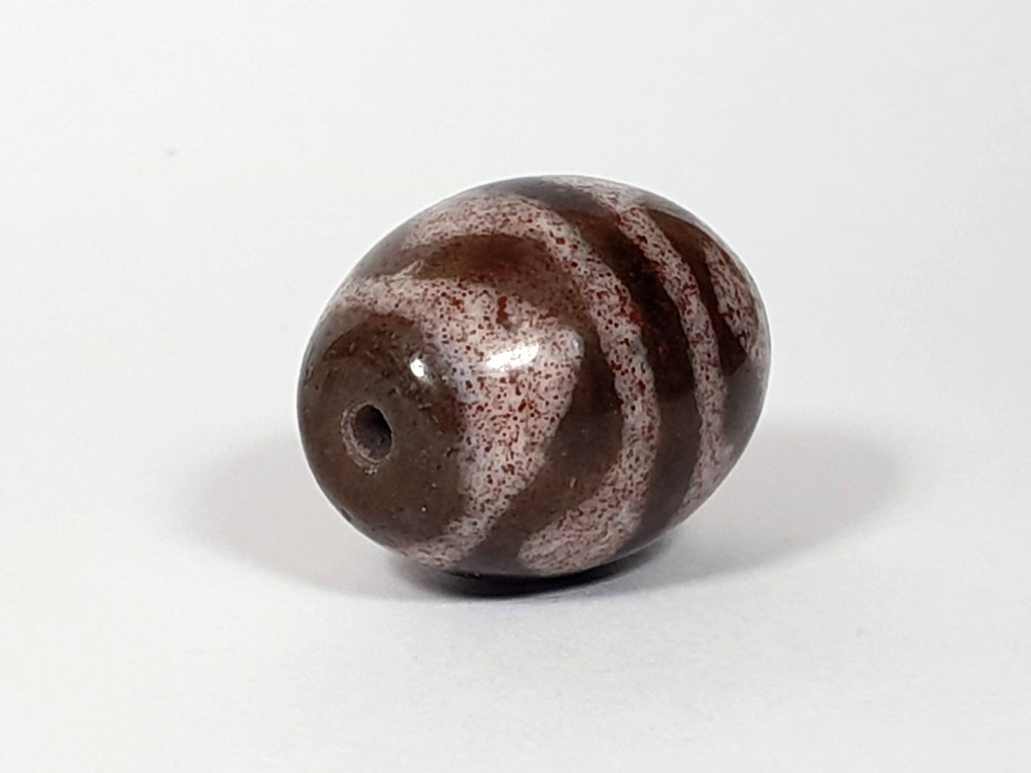 N-062926-TTBS2 Bead A, second rotation drill-end, dark chocolate-brown spherical agate, tiger tooth motif, unretouched