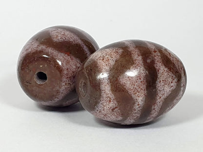 N-062926-TTBS2 pair shot, both beads, Bead A darker left, Bead B cream-ground right, tiger tooth motif, unretouched