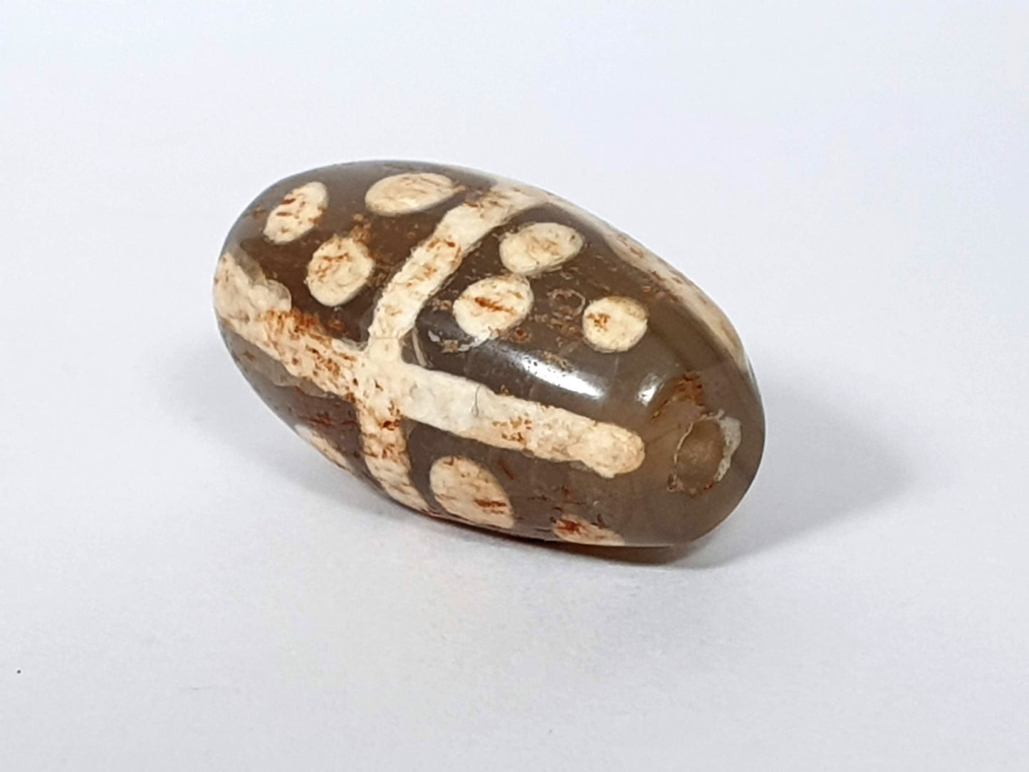 Ac-062426-18S Bead A medium warm brown ground star dots cross divider rust-brown mineral staining unretouched