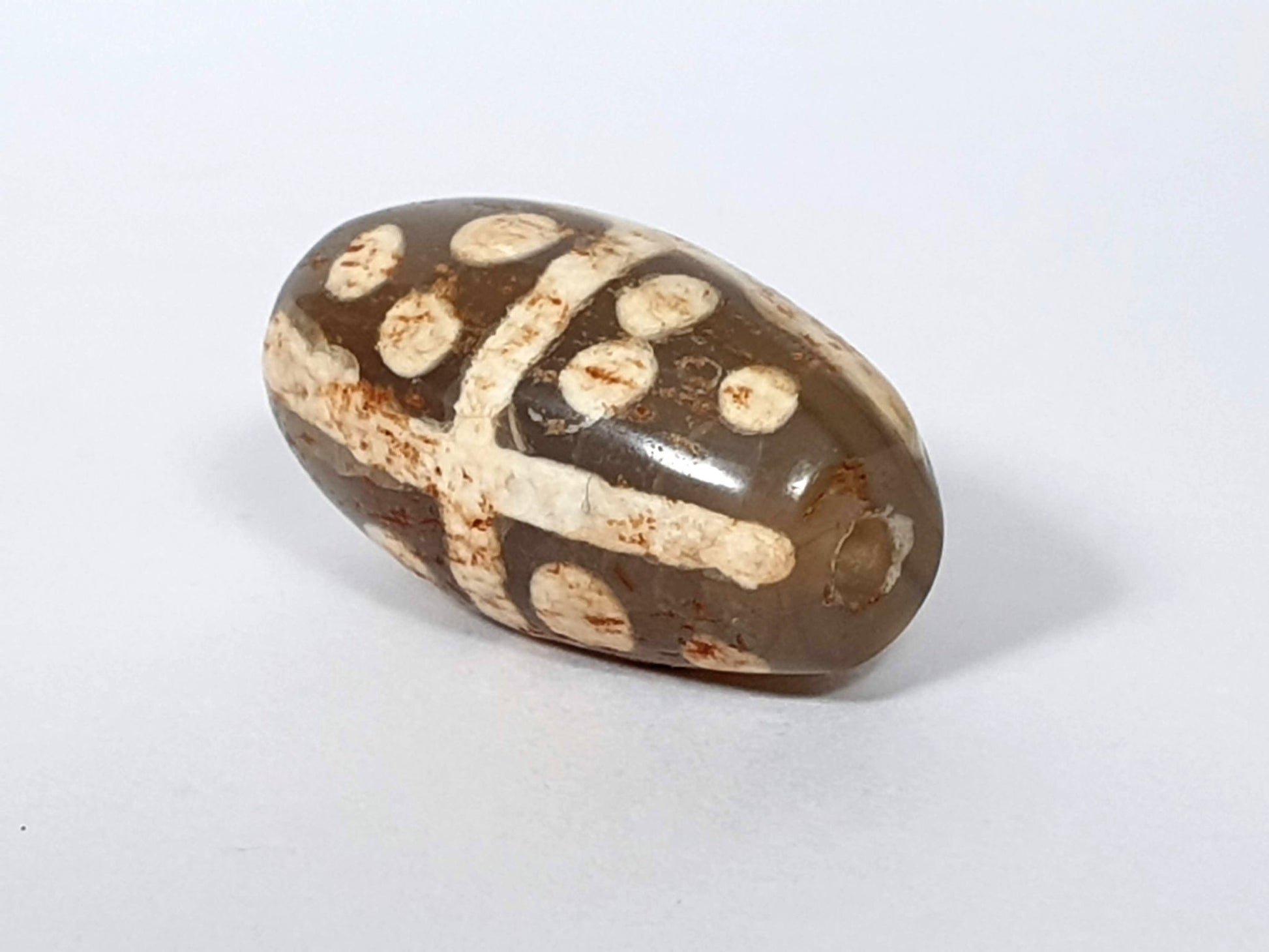 Ac-062426-18S Bead A medium warm brown ground star dots cross divider rust-brown mineral staining unretouched