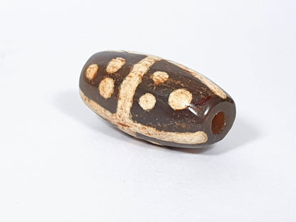 Ac-062426-18S Bead B deep dark warm brown ground star dots angled view ancient large drill hole unretouched