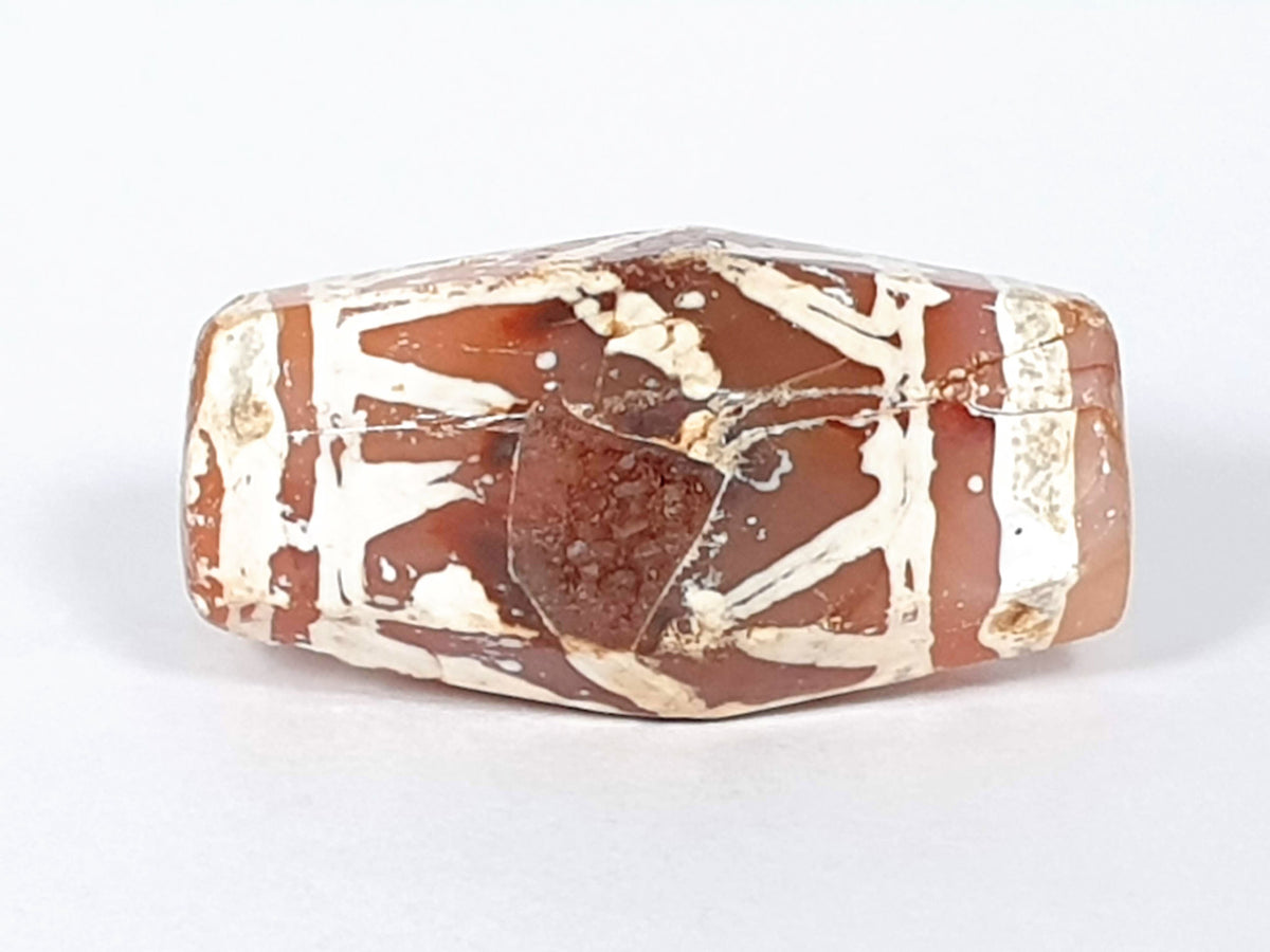 Ac-032320-LTT top face, triangular spall chip and hairline crack disclosed, terracotta-red ground, unretouched