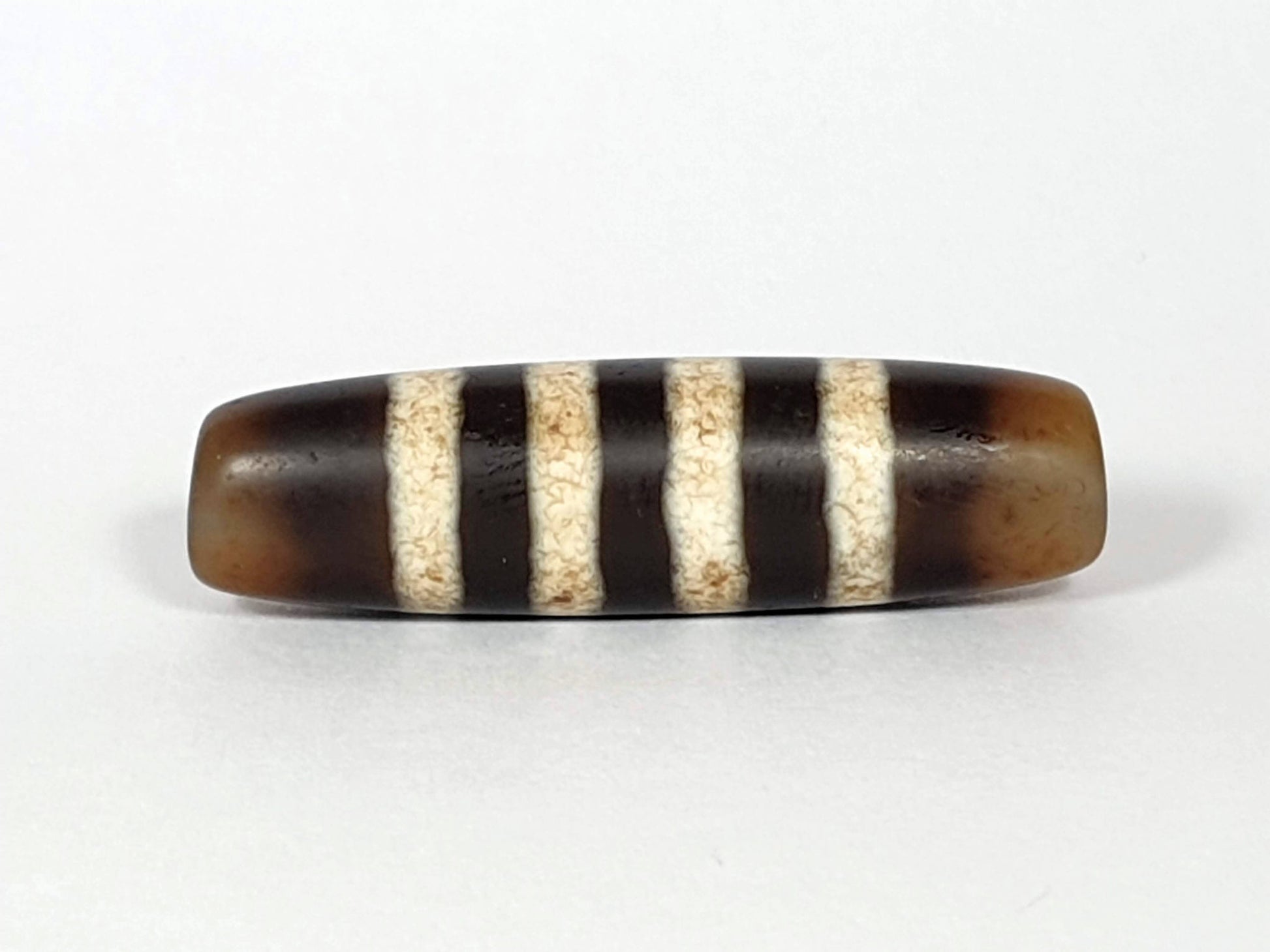 At-061920-7SChung antique seven stripe Chung dzi, 40.7×11.4mm, Face A, honey-brown ground, cream bands, unretouched