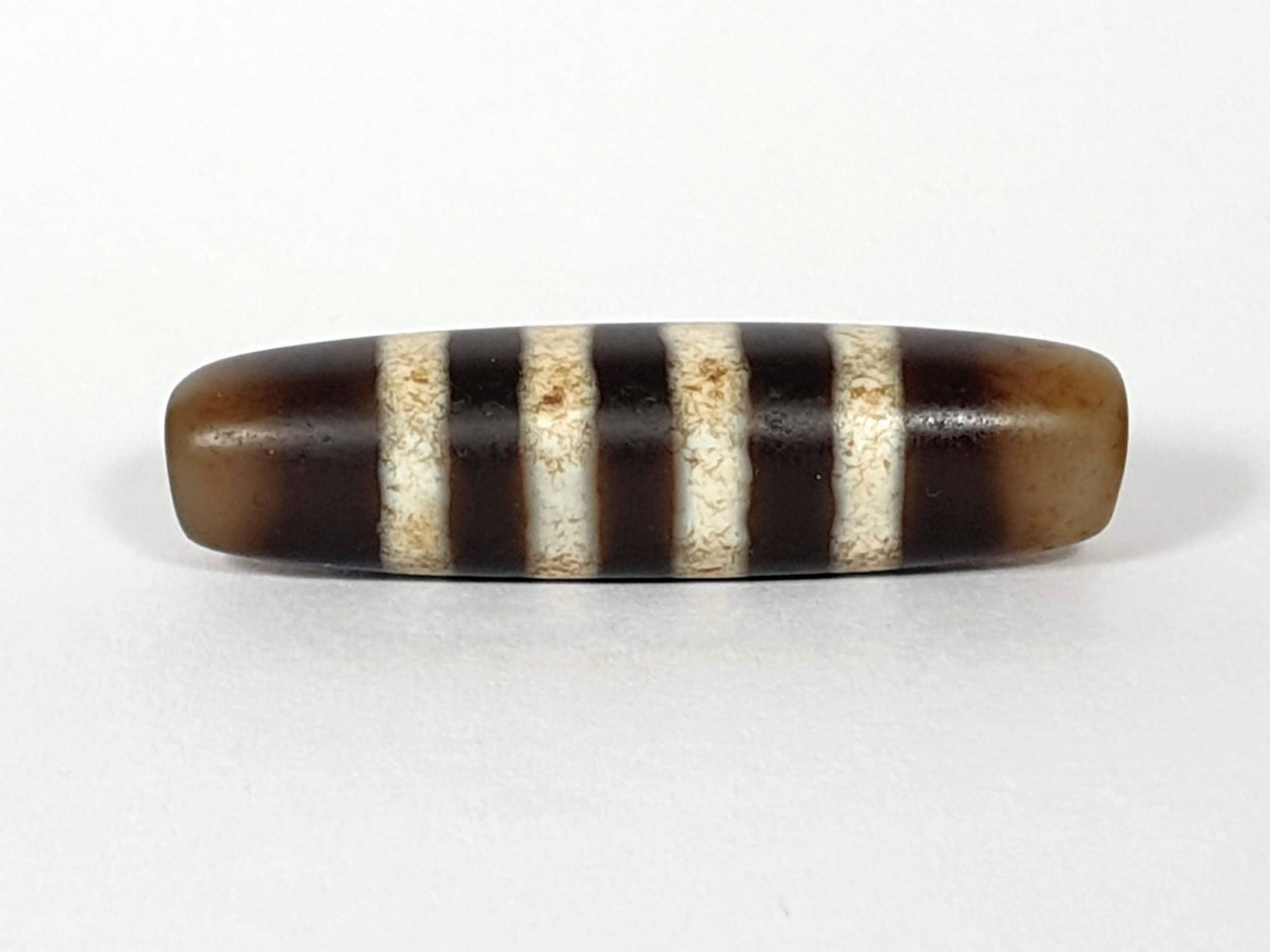 At-061920-7SChung antique seven stripe Chung dzi, Face B, translucent honey-brown end caps, warm ground, unretouched