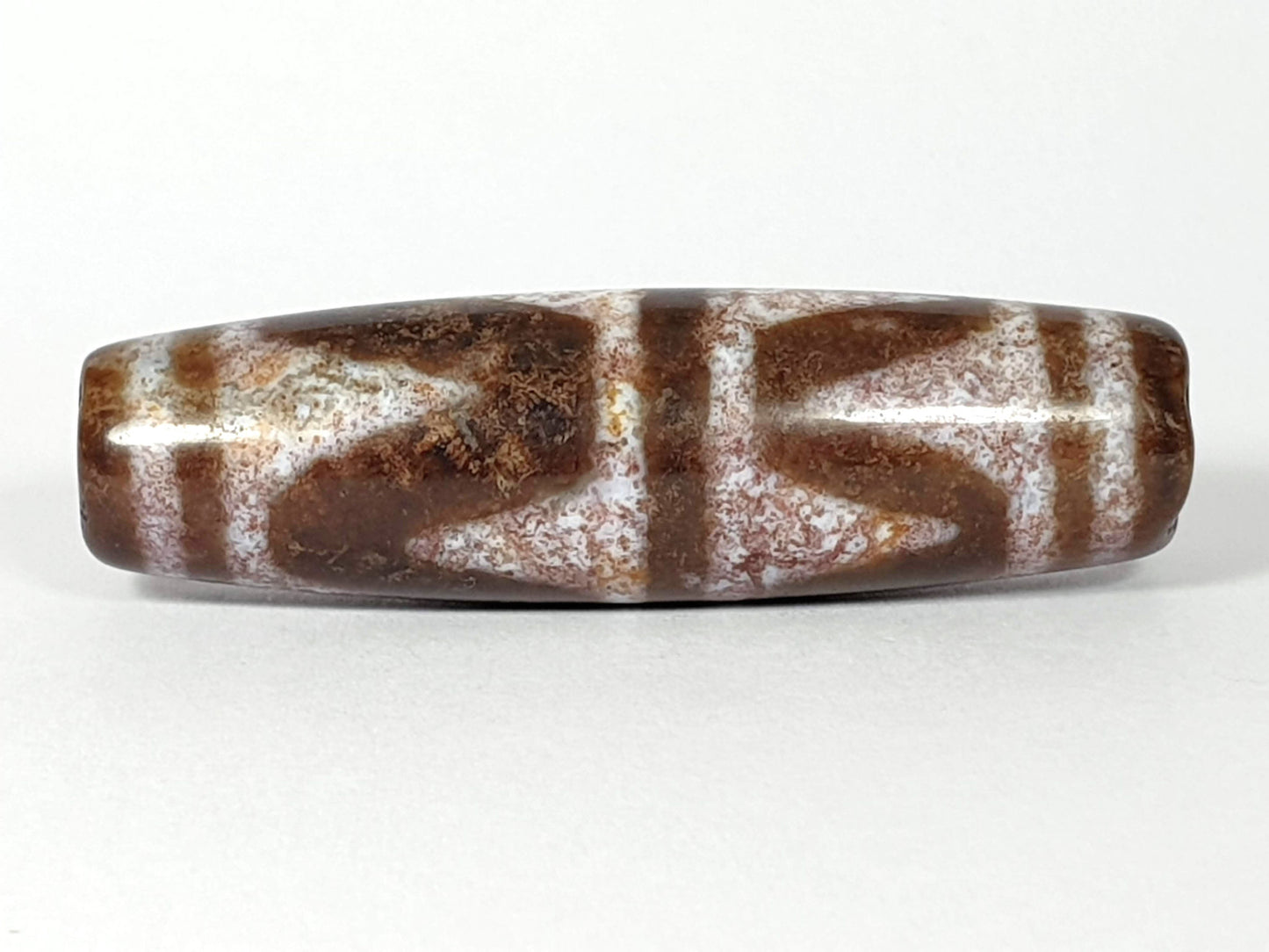 N-062126-DW dzi bead, opposite side profile, full chevron pattern visible, unretouched