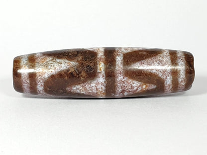 N-062126-DW dzi bead, opposite side profile, full chevron pattern visible, unretouched