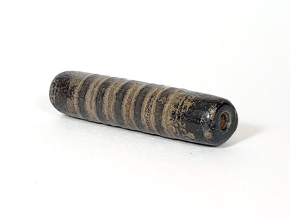 Ac-080420-19SChung, Bead B right end, large drill hole with reddish-brown interior, encrusted dark end cap, unretouched