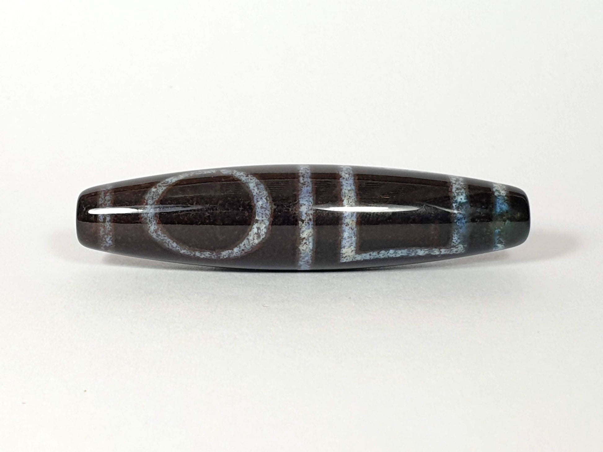 N-062126-HE dzi bead, straight side profile, ring eye and gate motif, unretouched