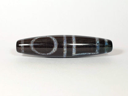 N-062126-HE dzi bead, straight side profile, ring eye and gate motif, unretouched