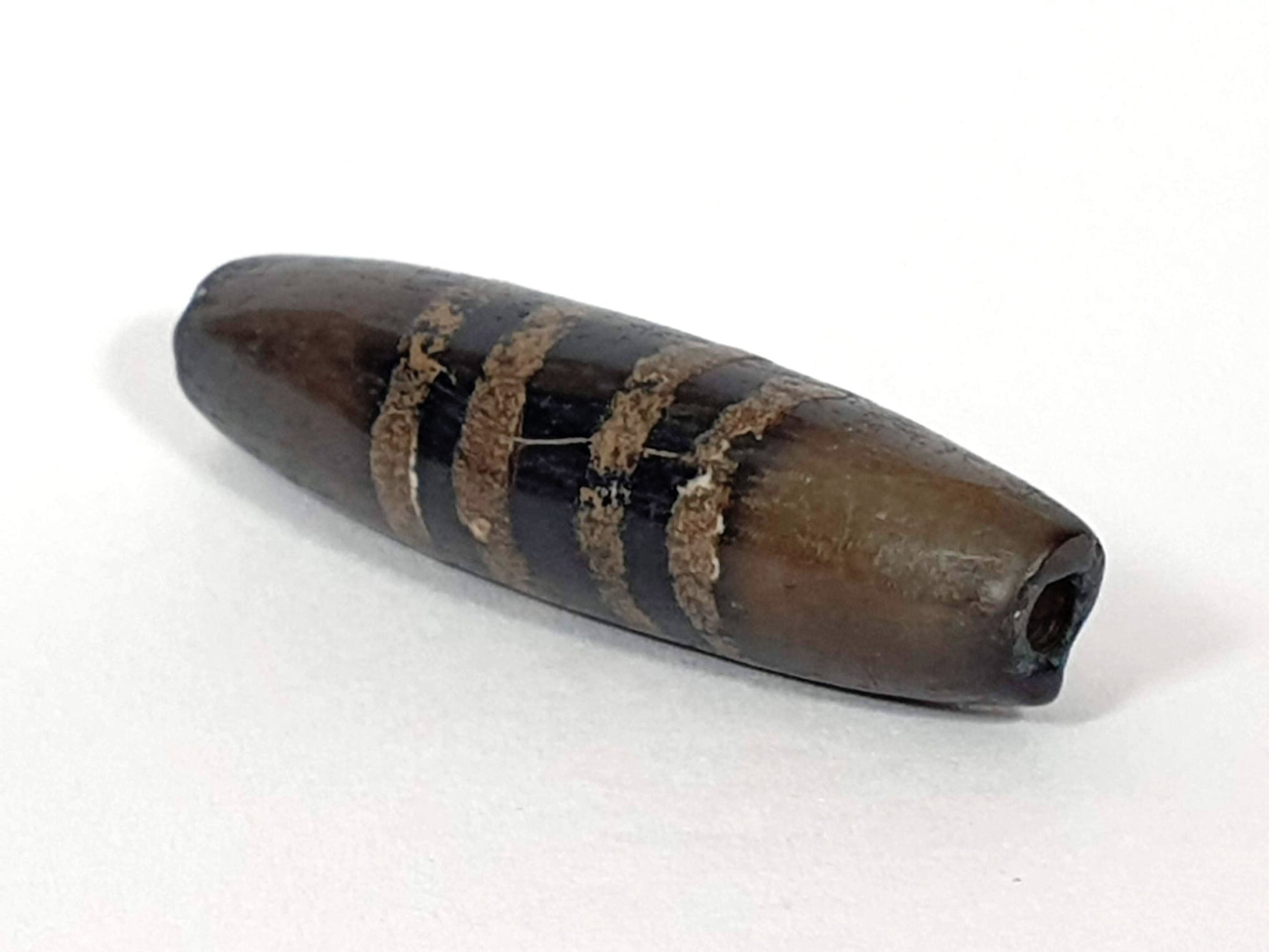Ac-080620-7SChung ancient Chung dzi, right end, intact tip, drill hole clean, warm dark brown end cap, unretouched