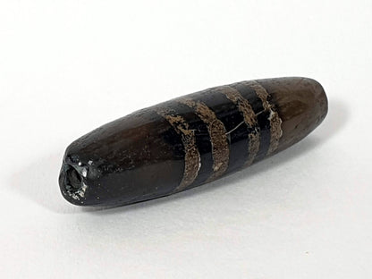 Ac-080620-7SChung ancient Chung dzi, left end, near-pitch-black end cap darkening, drill hole intact, unretouched