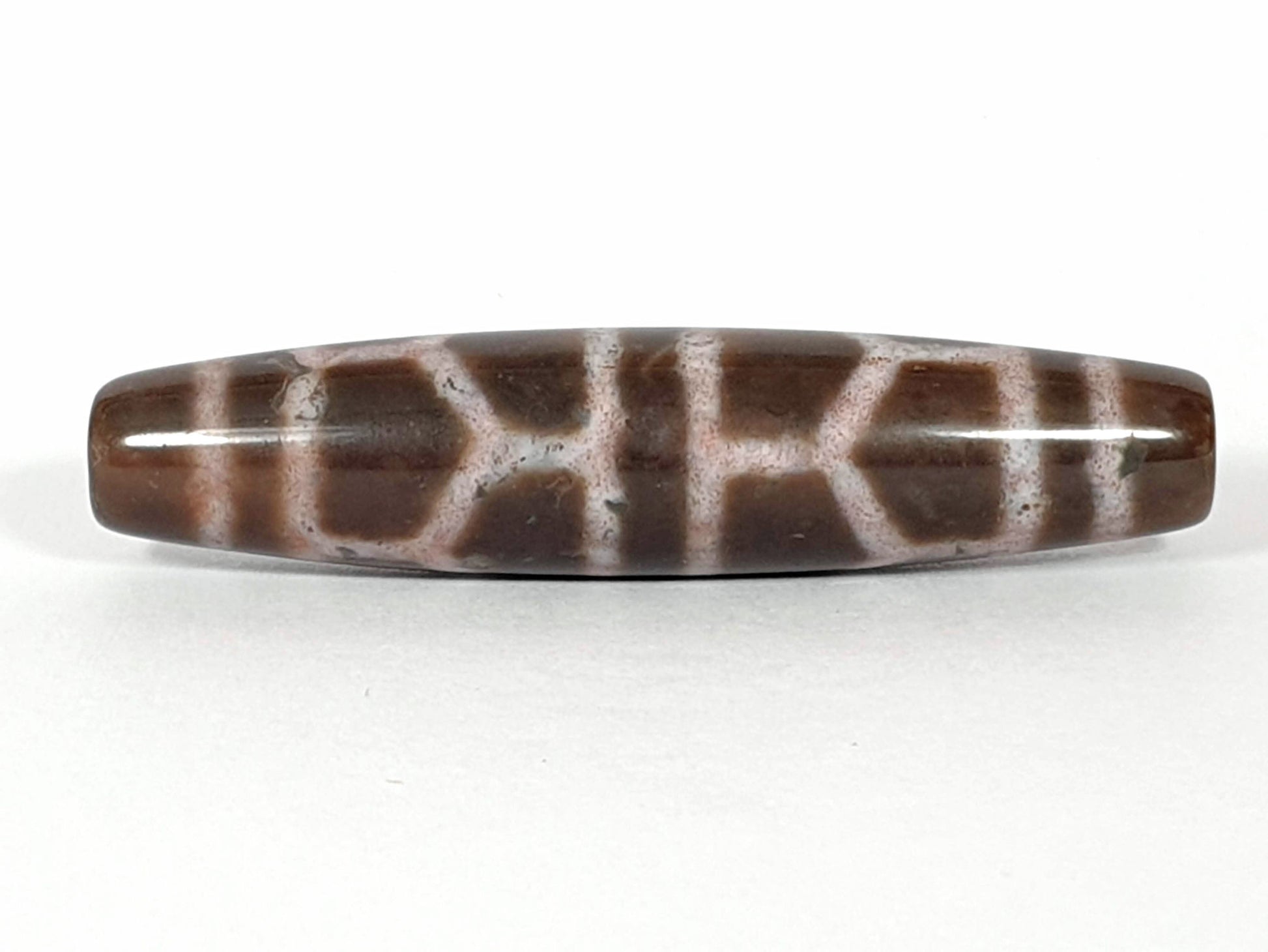 N-062226-DLBS, double longevity agate dzi, 58.1×13.1mm, warm brown, dusty rose-cream cell grid, face A, unretouched