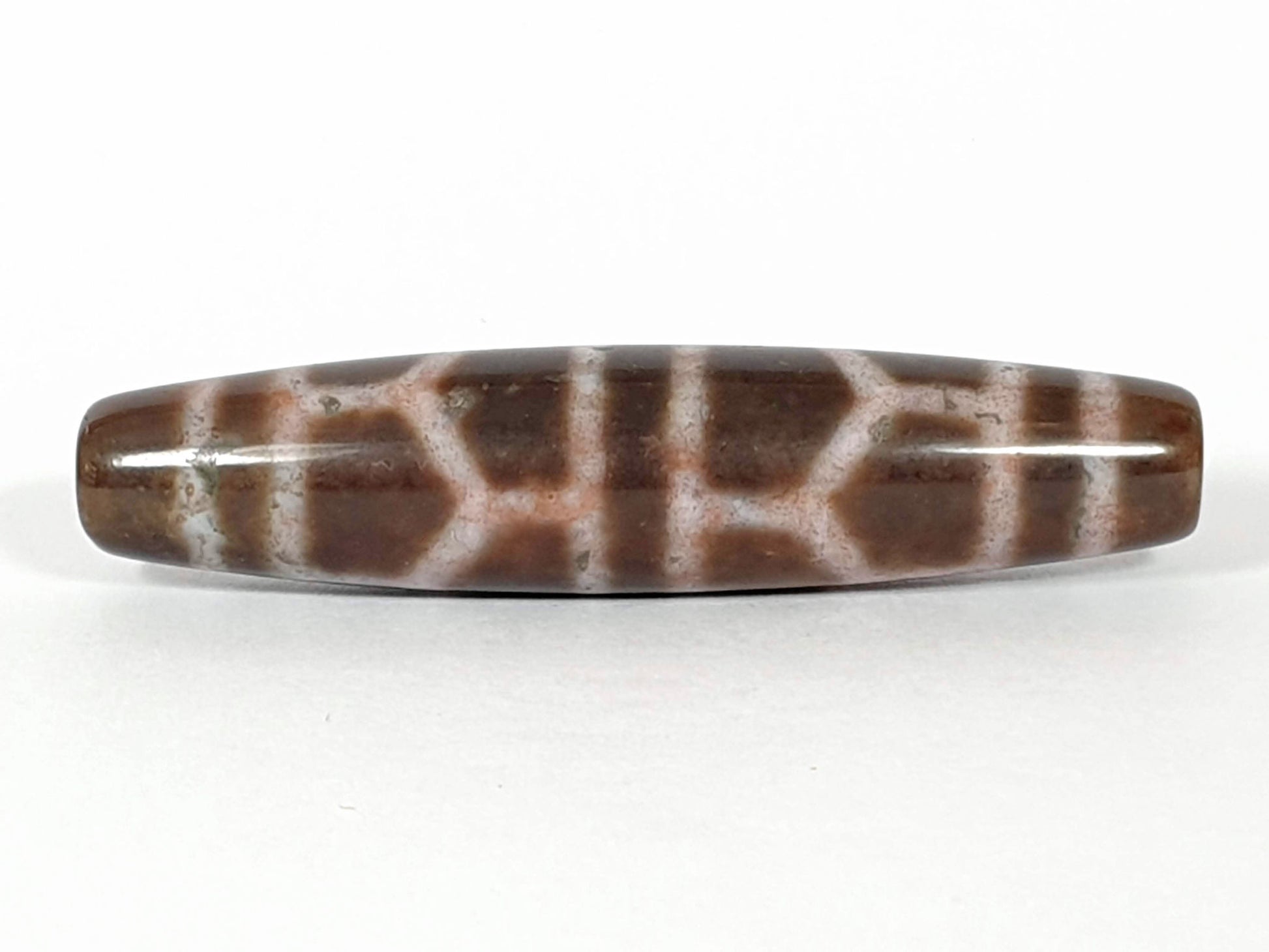 N-062226-DLBS, face B, double longevity cell grid, warm medium-dark brown ground, dusty rose-cream lines, unretouched
