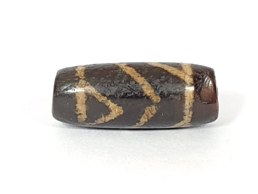 Ancient six-eye lotus motif carnelian dzi bead, dark brown agate, etched cream zigzag pattern, aged patina, visible drill hole