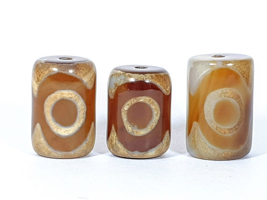 N-062626-3ESET set three new three eye agate dzi, front face, honey-brown caramel ground, 22.0–22.6×14.5–14.8mm, unretouched
