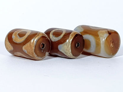 N-062626-3ESET set three new three eye dzi, drill end view, warm chocolate-brown end caps, clean holes, unretouched