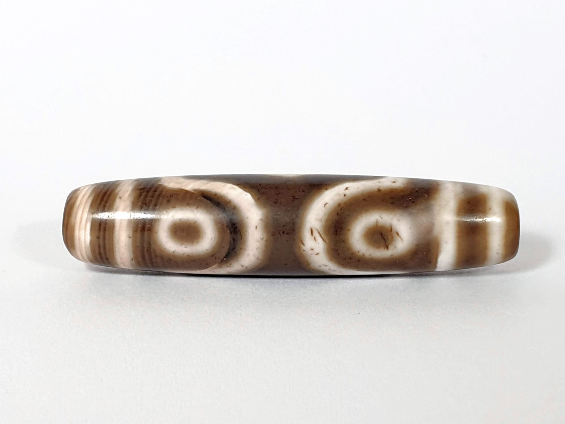 Qing Dynasty three eye dzi — reverse face, two oval eyes side by side, cream-brown agate, bracket right, At-0426-3EQ