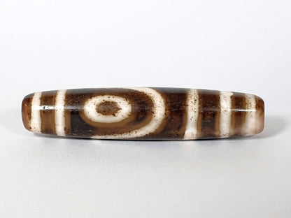 	Qing Dynasty two eye dzi — third face, second spiral eye on warm brown ground with pink-blush end, bracket bars, At-0426-2EQ