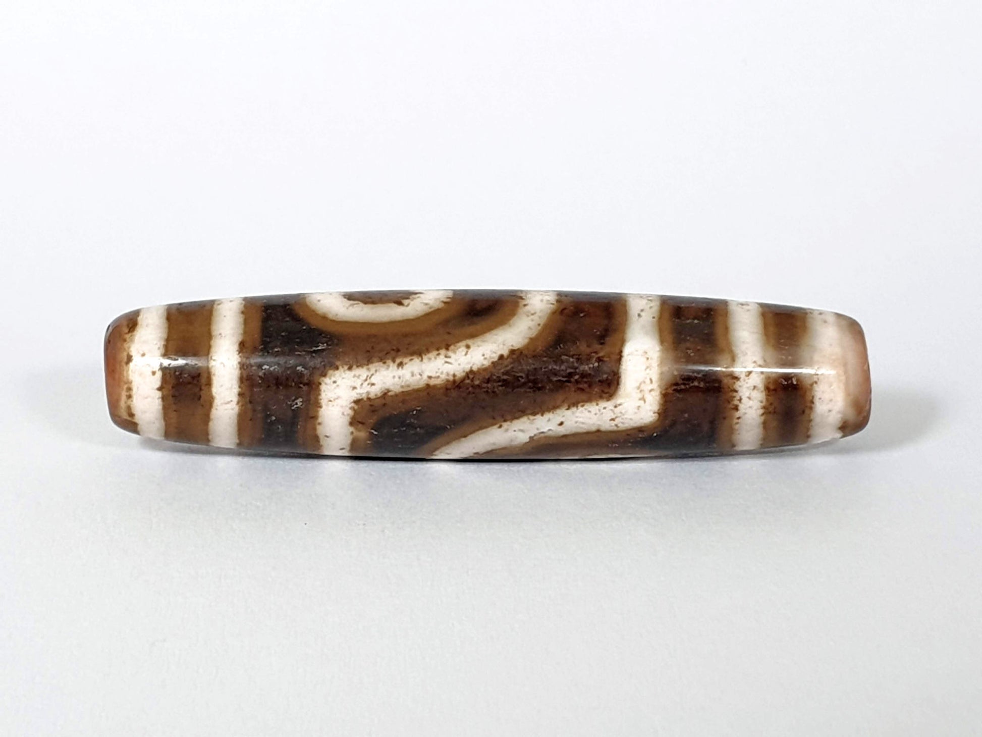 Qing Dynasty two eye dzi — fourth face, angular connector pattern, cream-dominant ground, agate banding visible, At-0426-2EQ