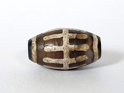 Ac-062426-SR Bead A warm chocolate-brown ground raised mineralised sun ray bars end view drill hole unretouched