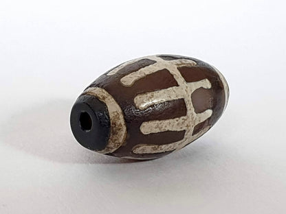 Ancient Sun Ray Motif Agate Dzi Bead with cream striping, dark patina, and center drill hole, 1200-1500 years old
