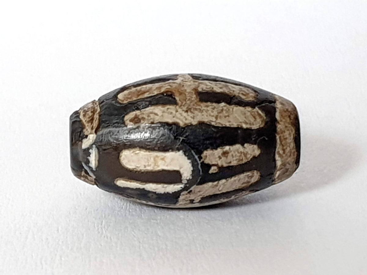 Antique sun ray motif agate dzi bead with cream striping and natural patina, 20mm