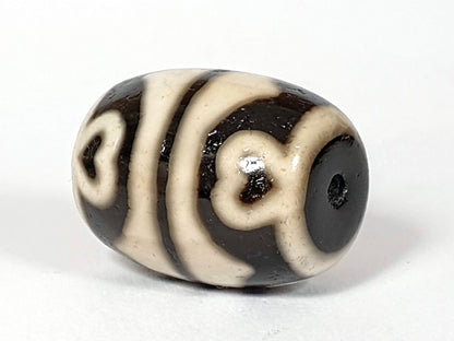 N-062226-TTSEL, side view showing continuous curved-line motif, drill hole end cap visible, cream-ground, unretouched