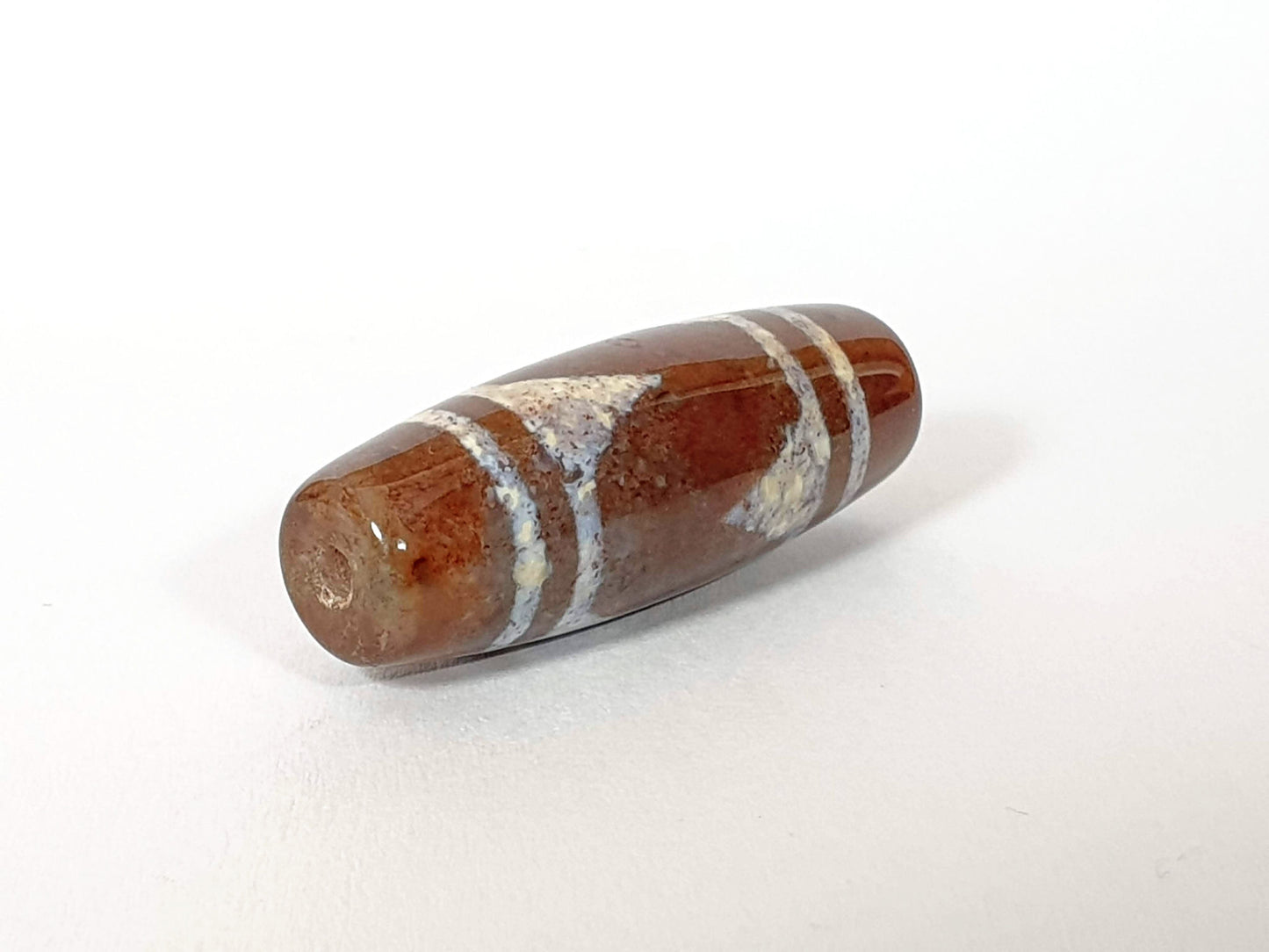 N-062426-TTBS Bead A tiger tooth dzi 39.4x13.6mm opposite end warm reddish-brown agate natural striation unretouched