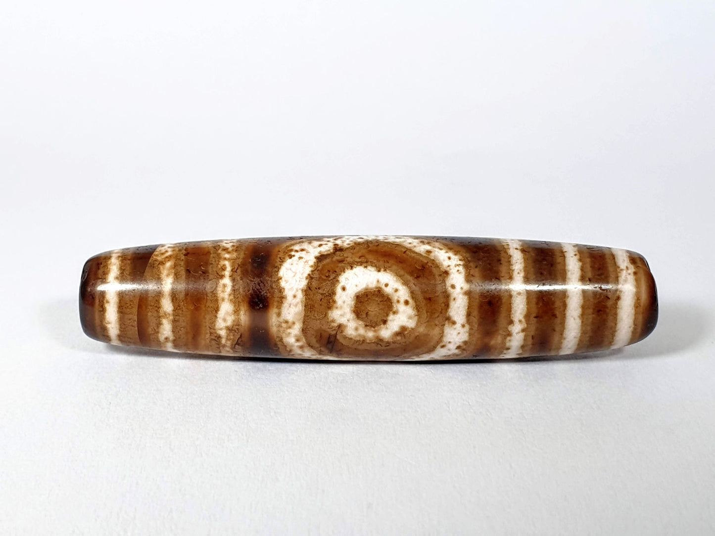 Qing Dynasty three eye dzi — front face, one large open eye centred, speckled cream zones, warm brown ground, At-0426-3EQ2