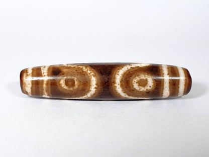 Qing Dynasty three eye dzi — reverse face, two open ring eyes, brown speckle across cream zones, At-0426-3EQ2