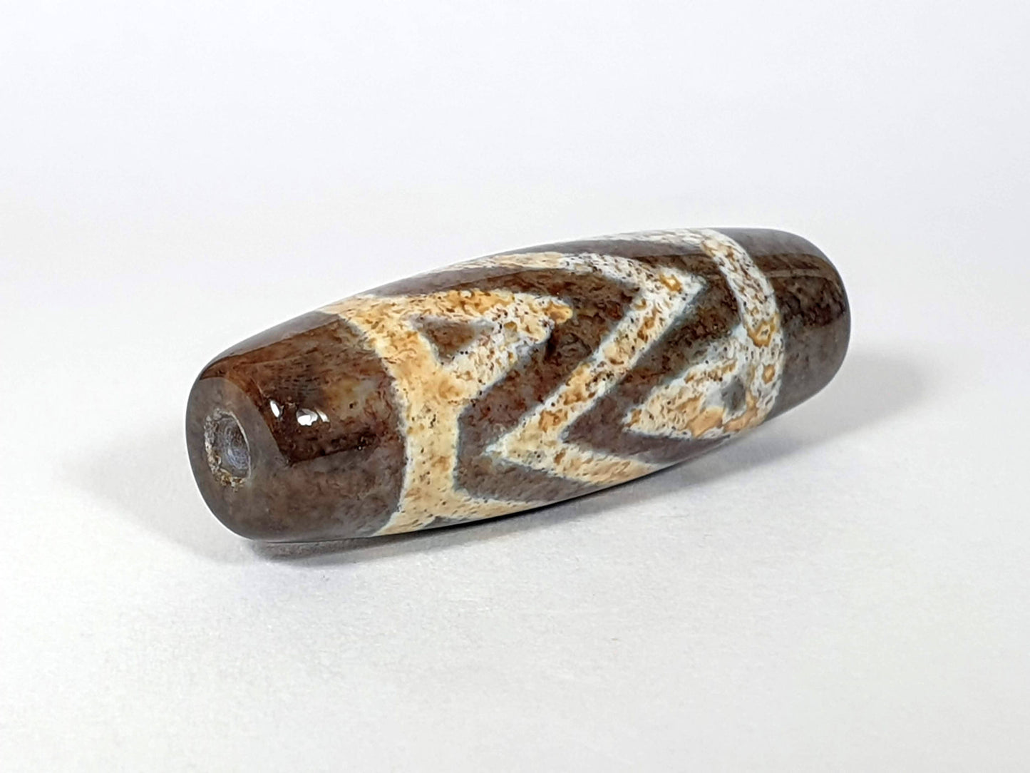 N-062426-3TSBS Bead A three stripe tiger dzi 39.7x13.8mm opposite end honey-gold warm motif drill hole unretouched