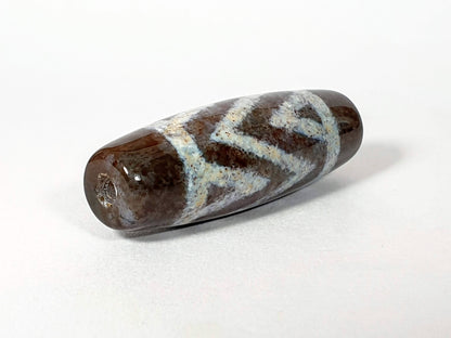 N-062426-3TSBS Bead B three stripe tiger dzi 39.6x13.8mm opposite end pale blue-grey motif drill hole unretouched