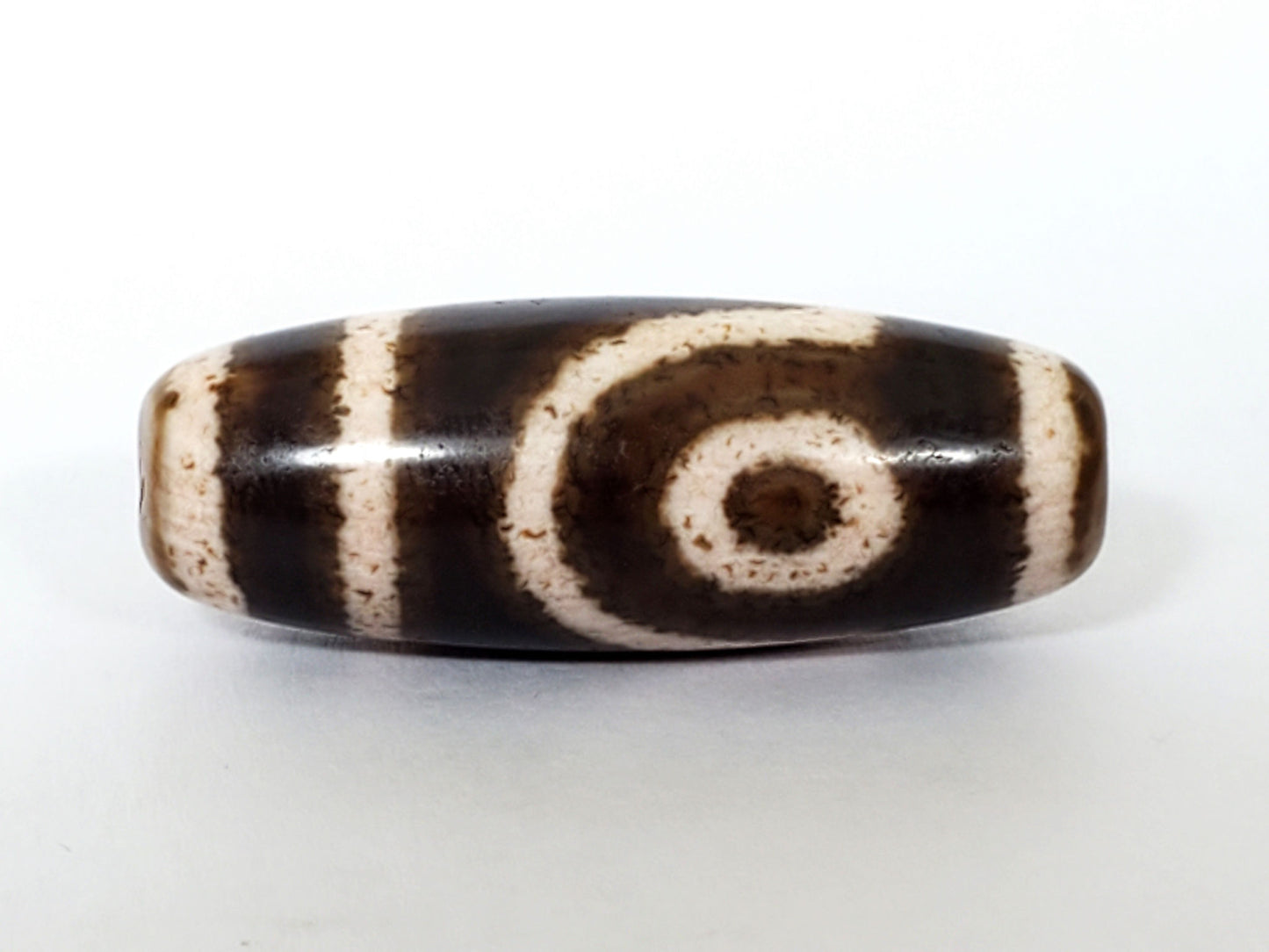 Qing Dynasty two eye dzi — front face, large bold spiral eye centred, dark brown ground, speckled cream zones, At-0426-2EQ2