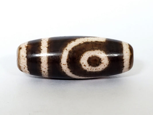 Qing Dynasty two eye dzi — front face, large bold spiral eye centred, dark brown ground, speckled cream zones, At-0426-2EQ2