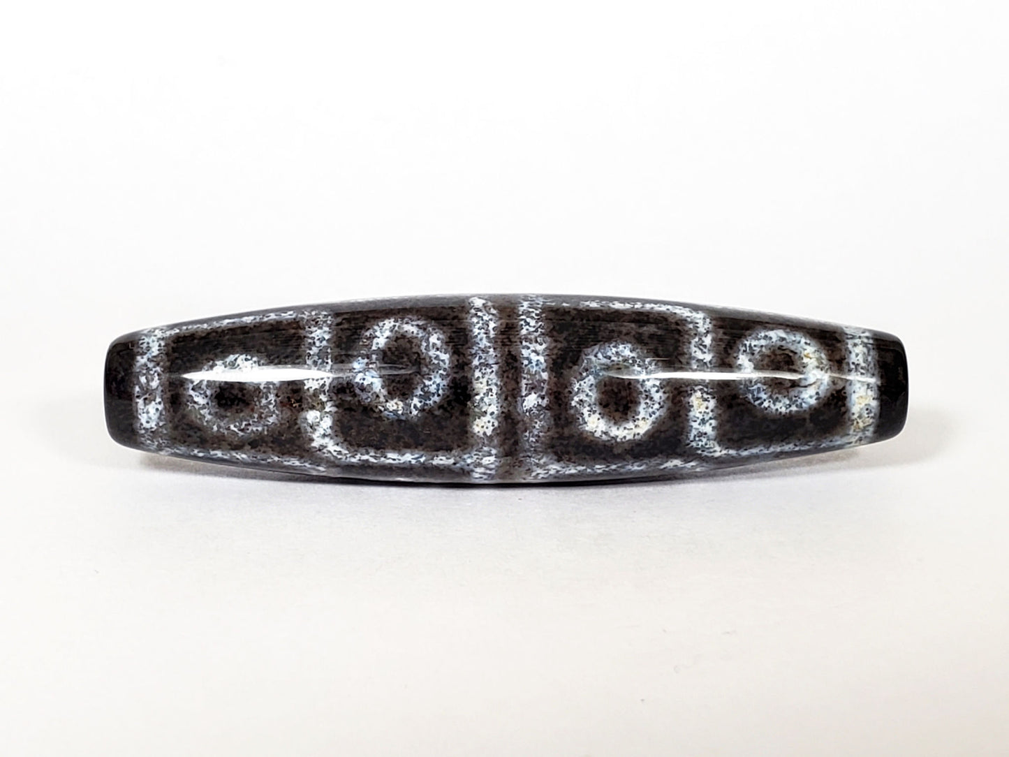 N-062126-12E-2 dzi bead, straight side profile, twelve ring eyes visible, unretouched