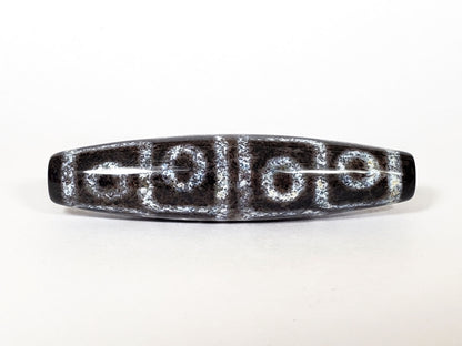 N-062126-12E-2 dzi bead, straight side profile, twelve ring eyes visible, unretouched