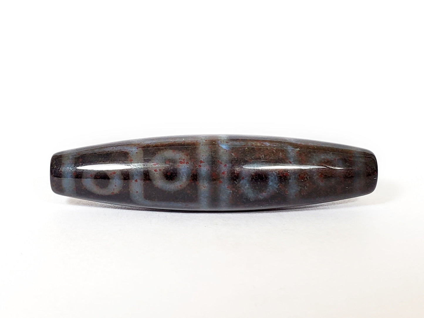 N-062126-12E-1 dzi bead, straight side profile, twelve ring eyes visible, unretouched