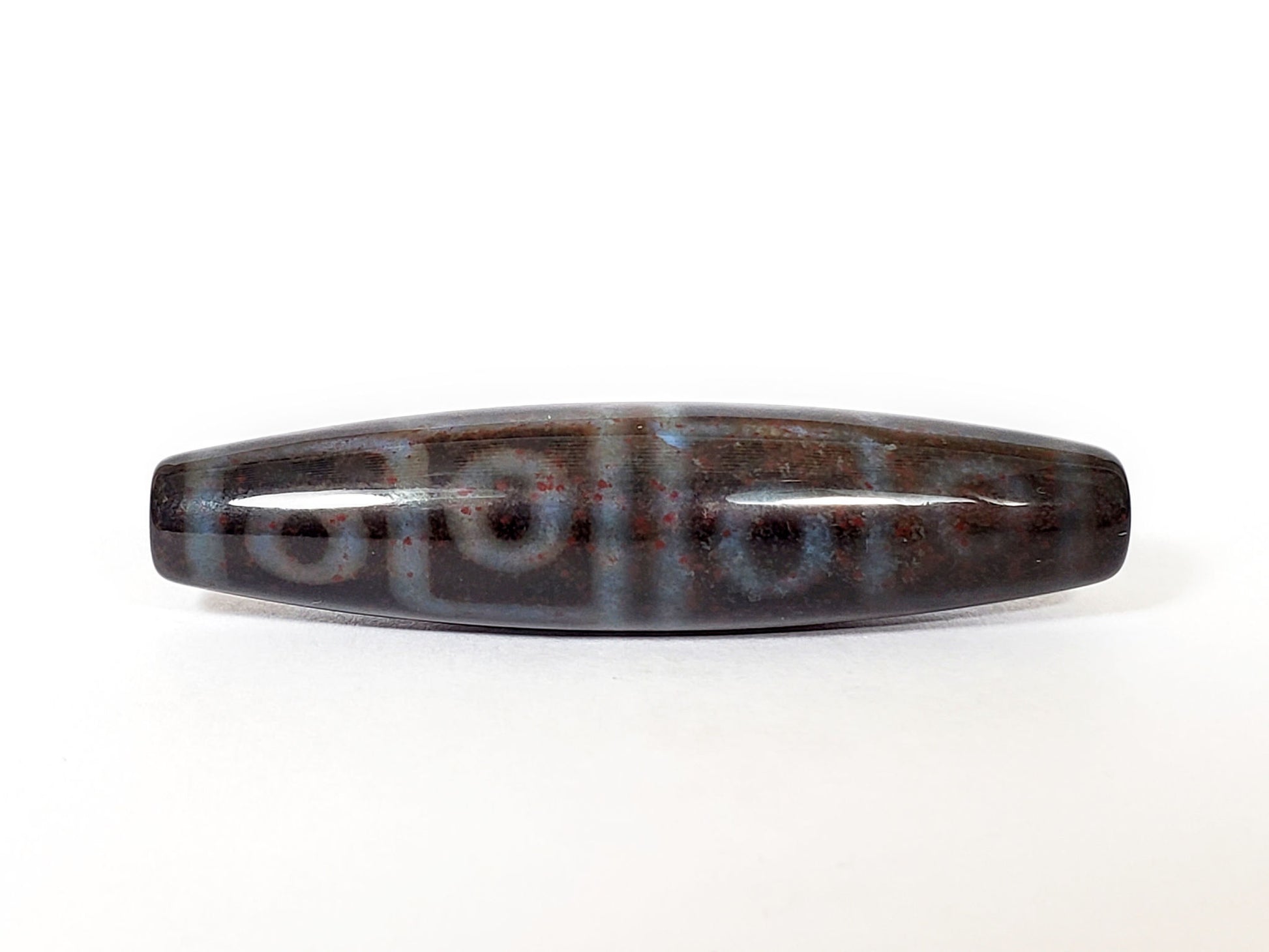 N-062126-12E-1 dzi bead, straight side profile, twelve ring eyes visible, unretouched
