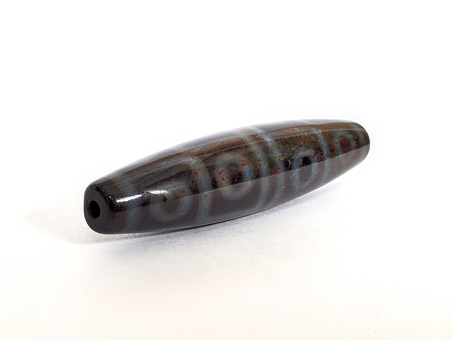 N-062126-12E-1 dzi bead, opposite angle, full motif sequence and end detail, unretouched